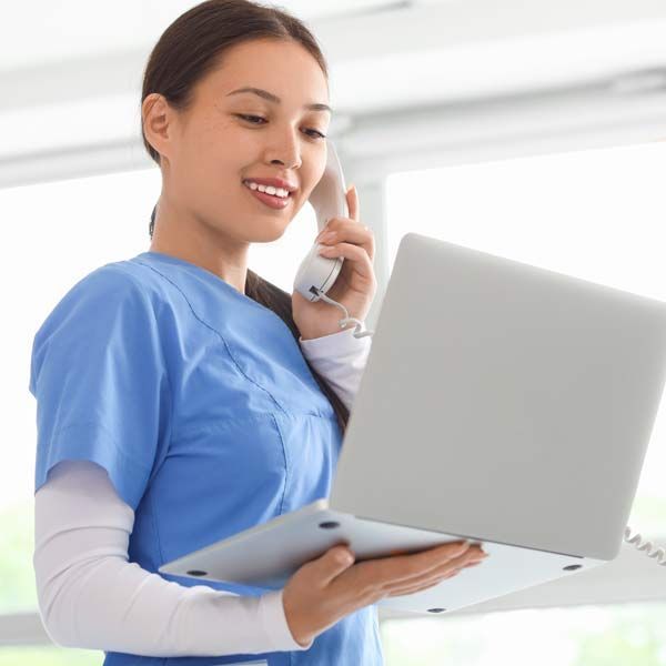 Medical Receptionist waits for people to Contact Victory Medical Institute for a Consultation on Tissue Healing NJ and Manhattan NY