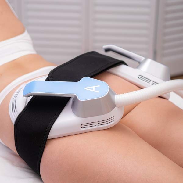 A woman is lying on a bed getting Medical Weight Loss and Body Contouring