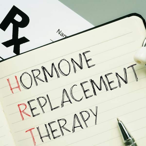 A notebook with the words hormone replacement therapy written on it