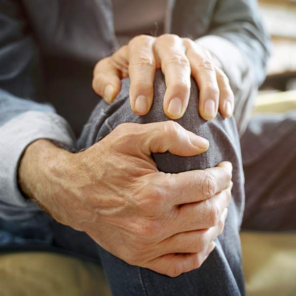 Man with Osteoarthritis holding his knee
