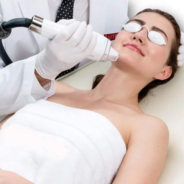 A woman is getting a treatment for Phototherapy and Light-based Photofacials Reveal Clear, Flawless Skin