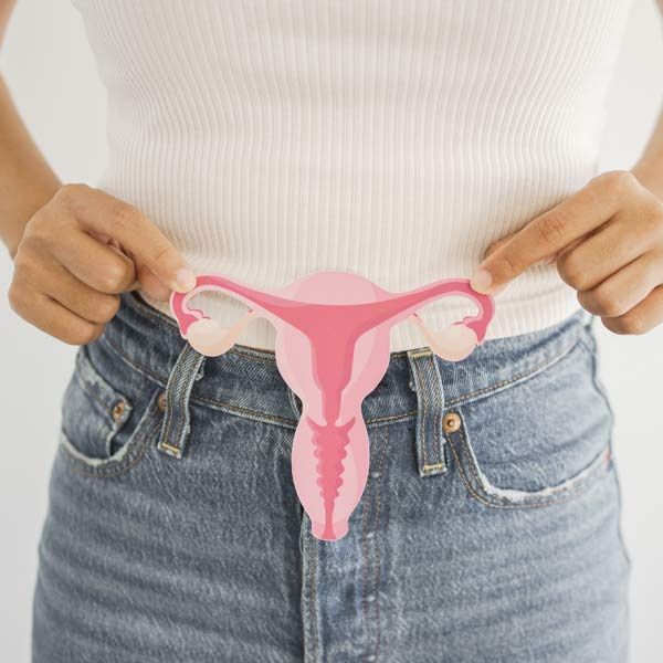 woman holding a Polycystic Ovary Syndrome sign over her midsection