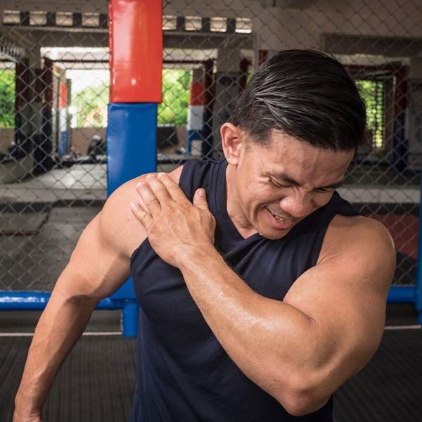 A man is holding his shoulder in pain in a gym needing Advanced Joint Pain Relief with Orthobiologic Therapy Serving Patients in Morris Plains New Jersey and Manhattan New York