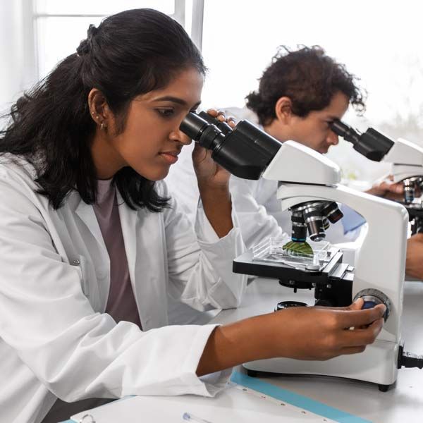 Two scientists are looking through microscopes in a lab Advanced Regenerative Organ Therapy is a Breakthrough in Healing and Restoration Serving Patients in Morris Plains New Jersey and Manhattan New York