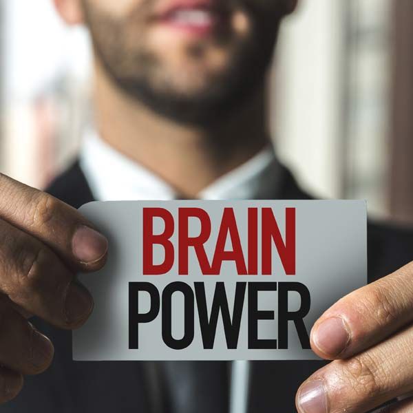A man is holding a card that says brain power representing The Mind for Mental Clarity IV Therapy