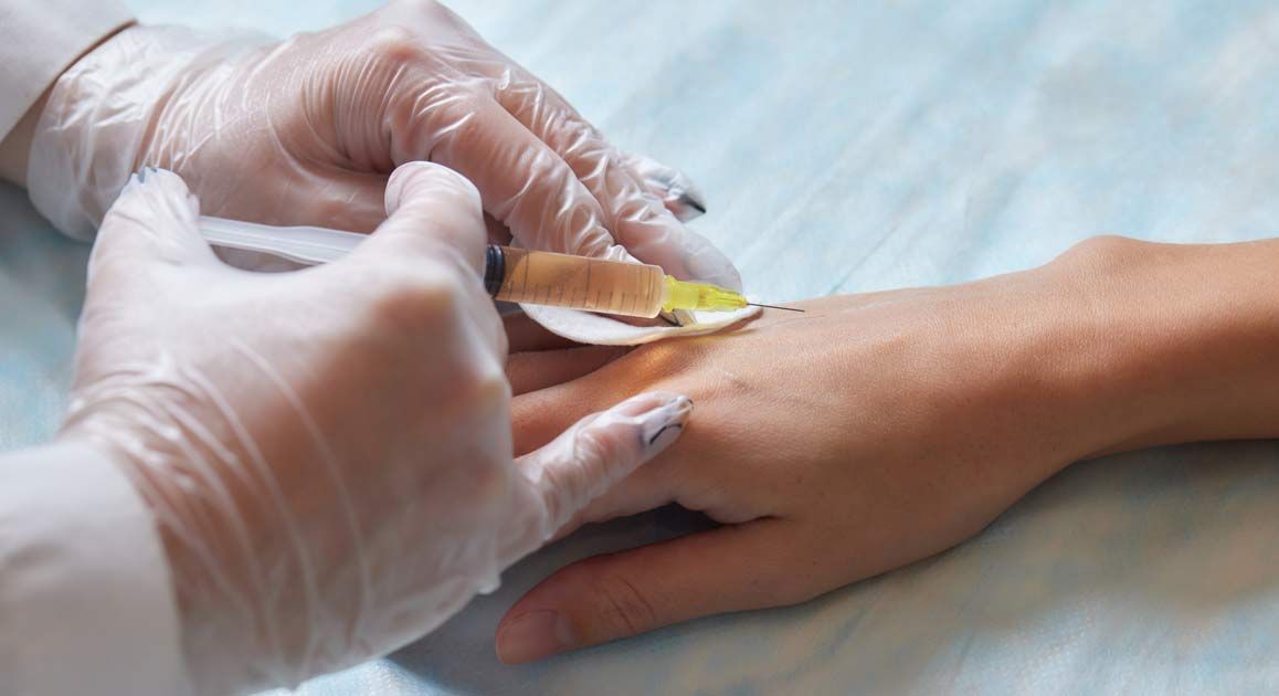 A person is getting an injection in their hand for Tissue Repair Treatments NJ and NYC - Victory Medical Institute
