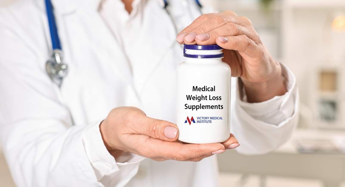 A doctor is holding a bottle of weight loss supplements in his hands, representing Weight Loss Supplements NJ and NYC at Victory Medical Institute