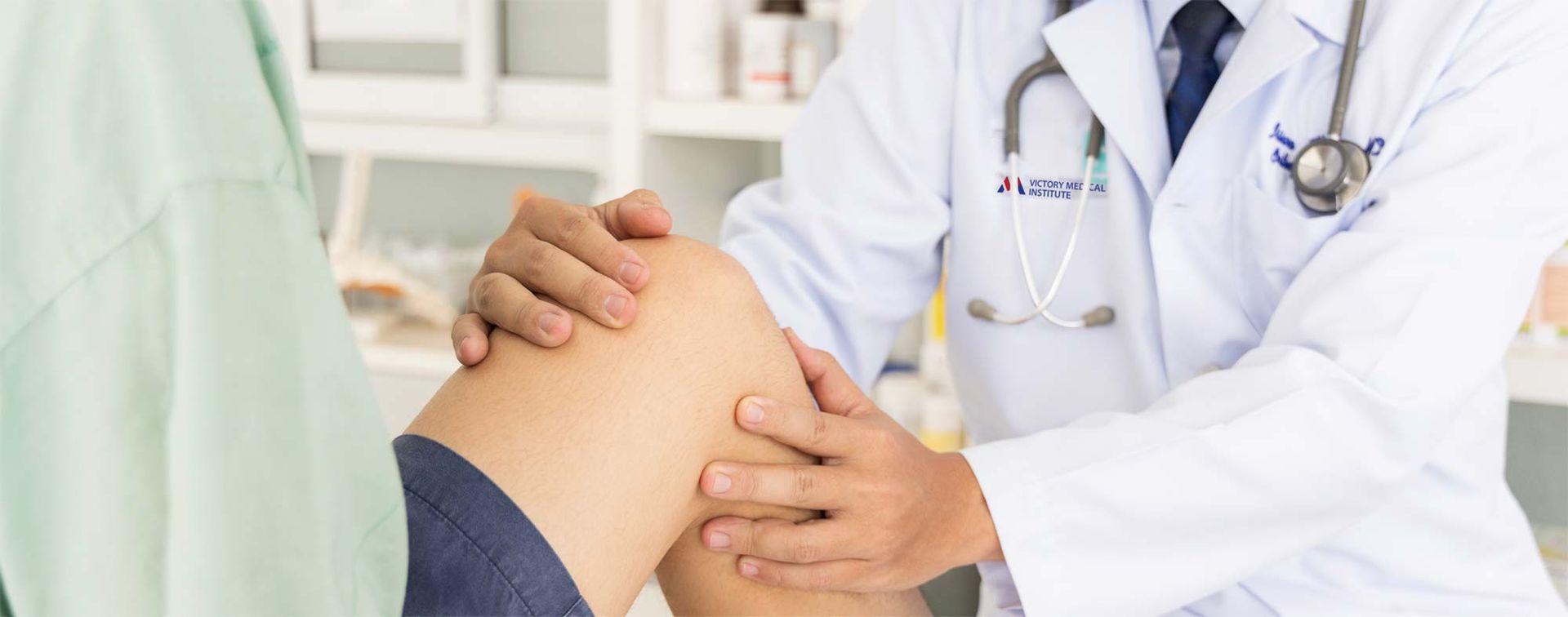 A doctor is examining a patient's knee for Orthobiological treatments.