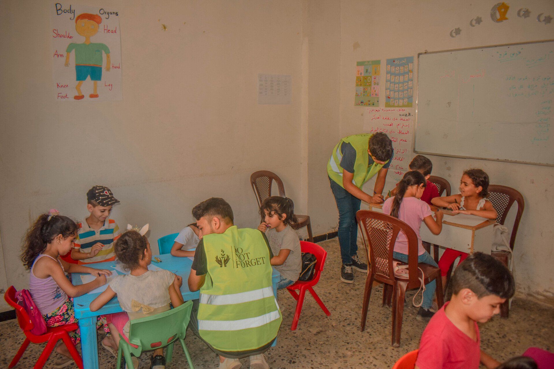 A picture of volunteers working with kids