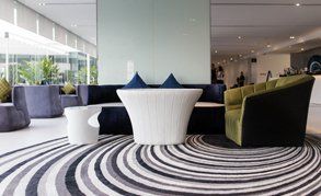 A carpet in a reception area with a swirling design on it