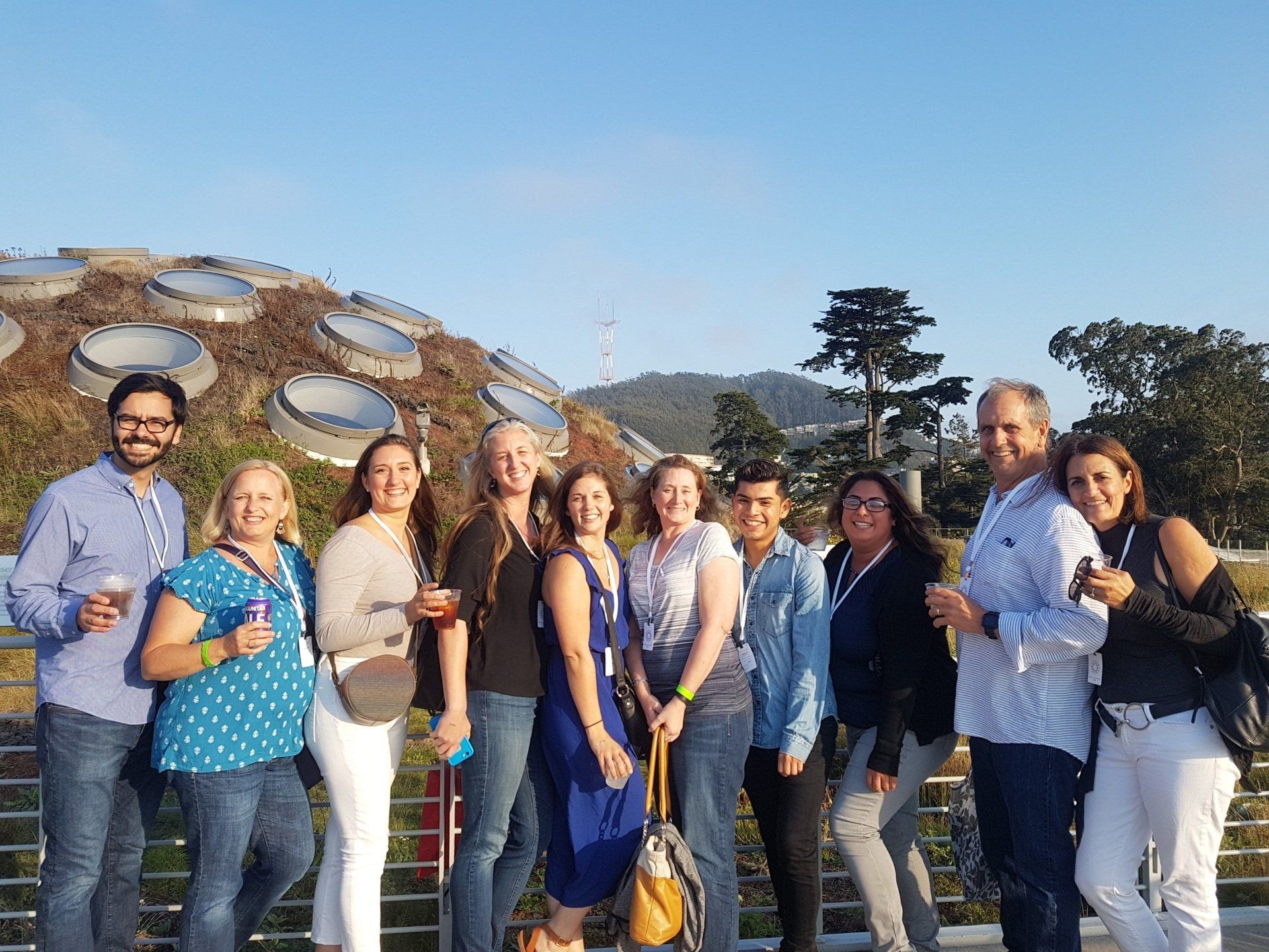 A group of people are posing for a picture in front of a building.
