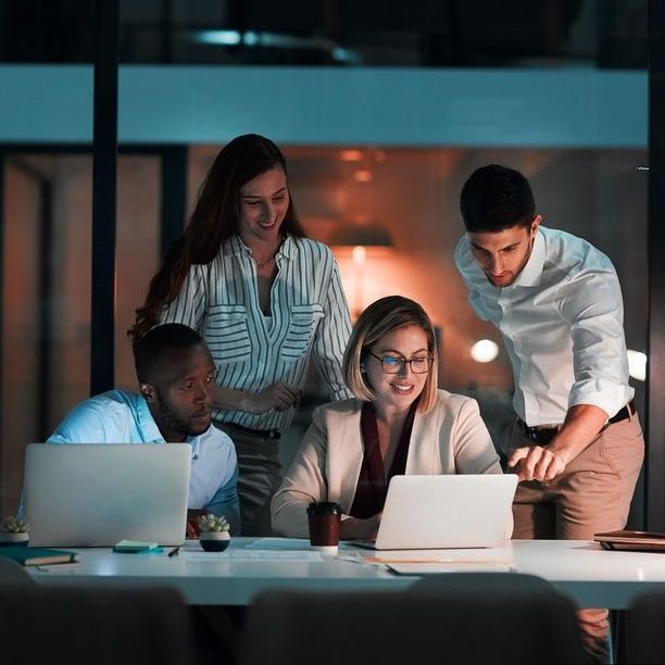 An employer and staff members looking over a PEO plan together