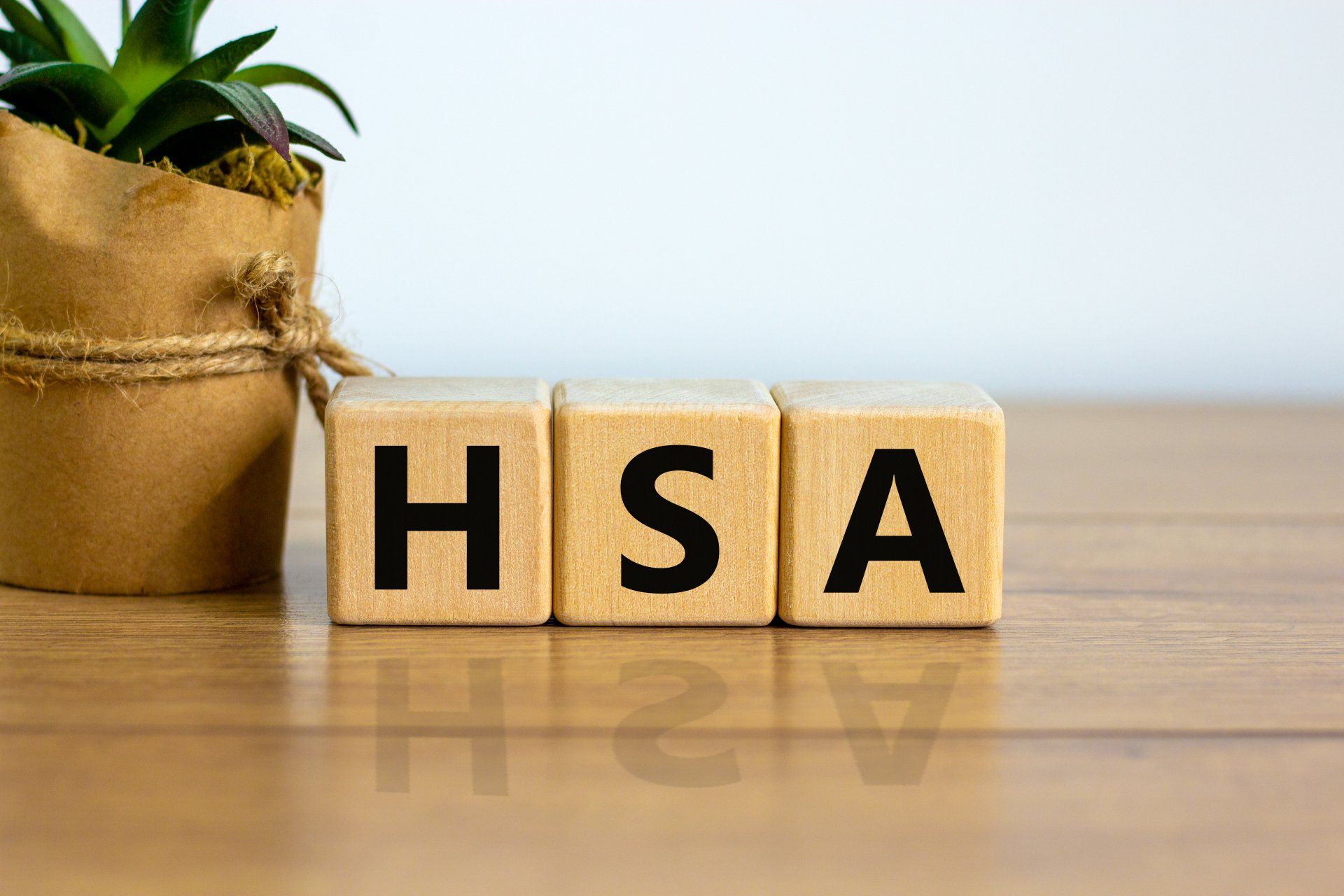 The word hsa is written on wooden blocks on a wooden table.