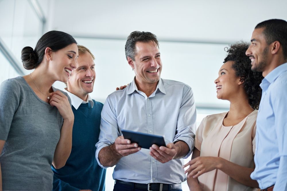 A woman is sitting at a desk with a laptop and a calculator.