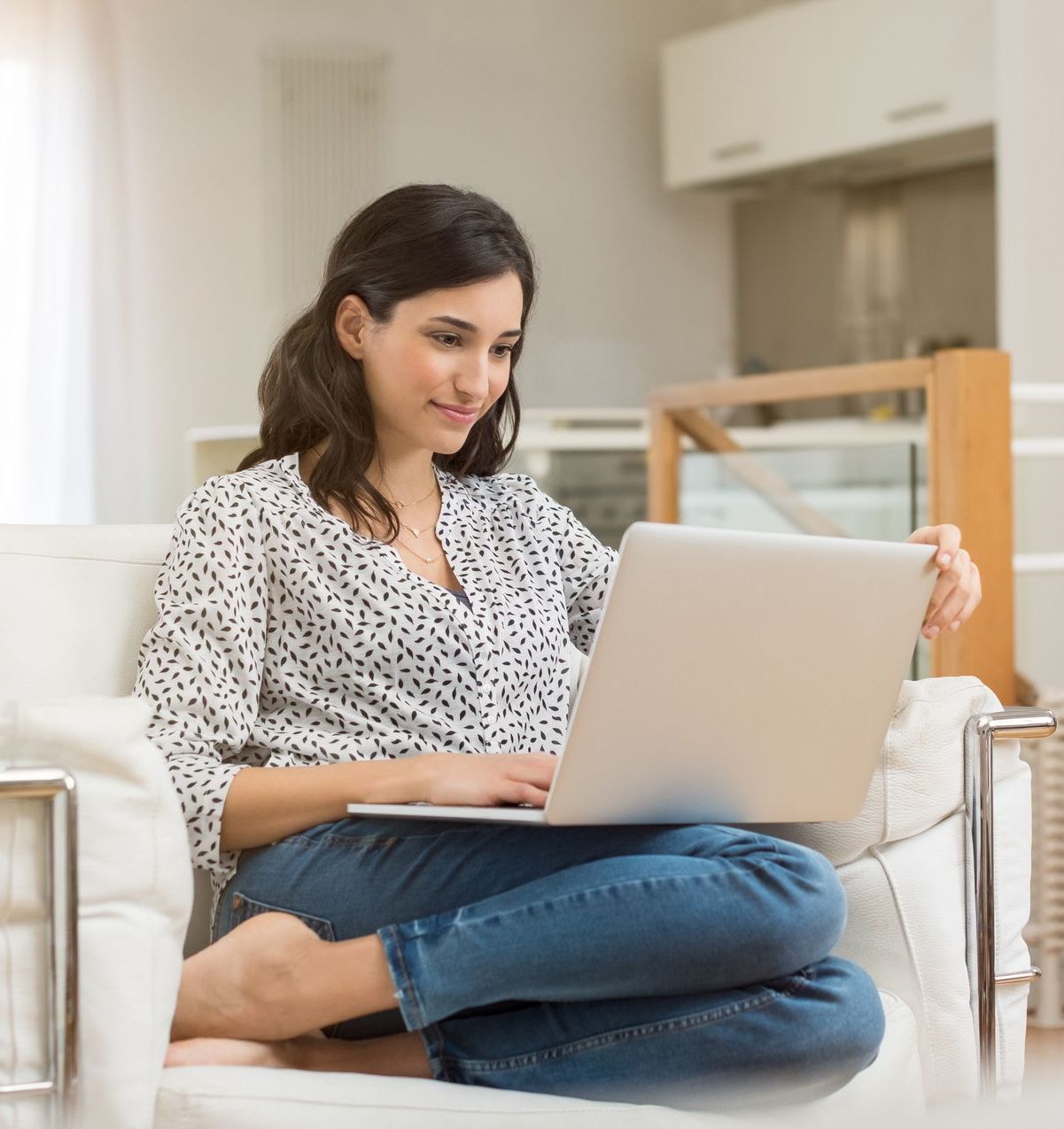 A young woman is on her laptop looking for a new Modesto Employee Benefits Broker