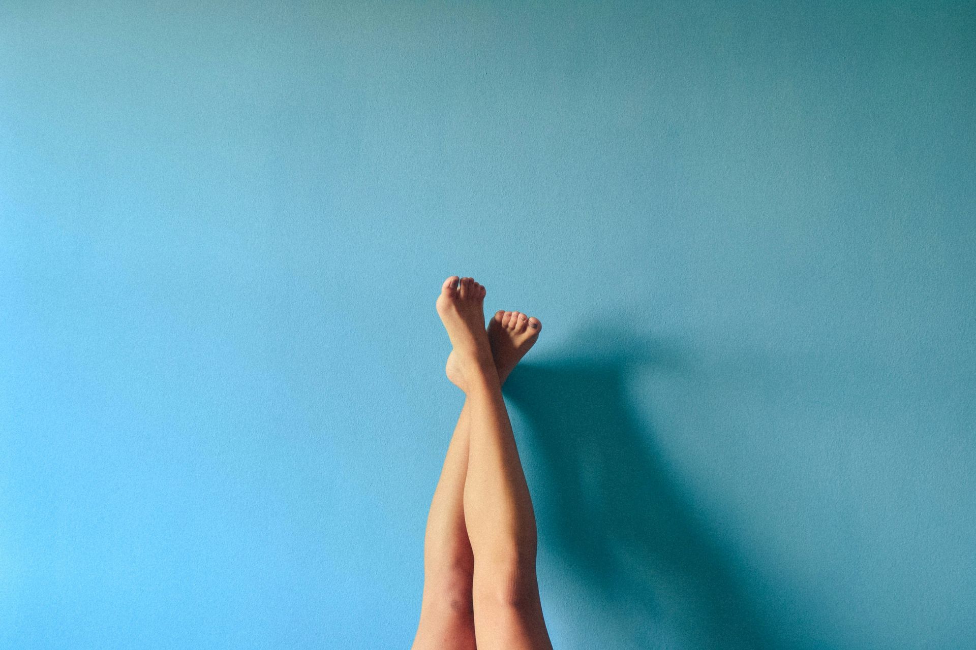 Woman following a waxing schedule for smooth, soft skin at a professional spa setting