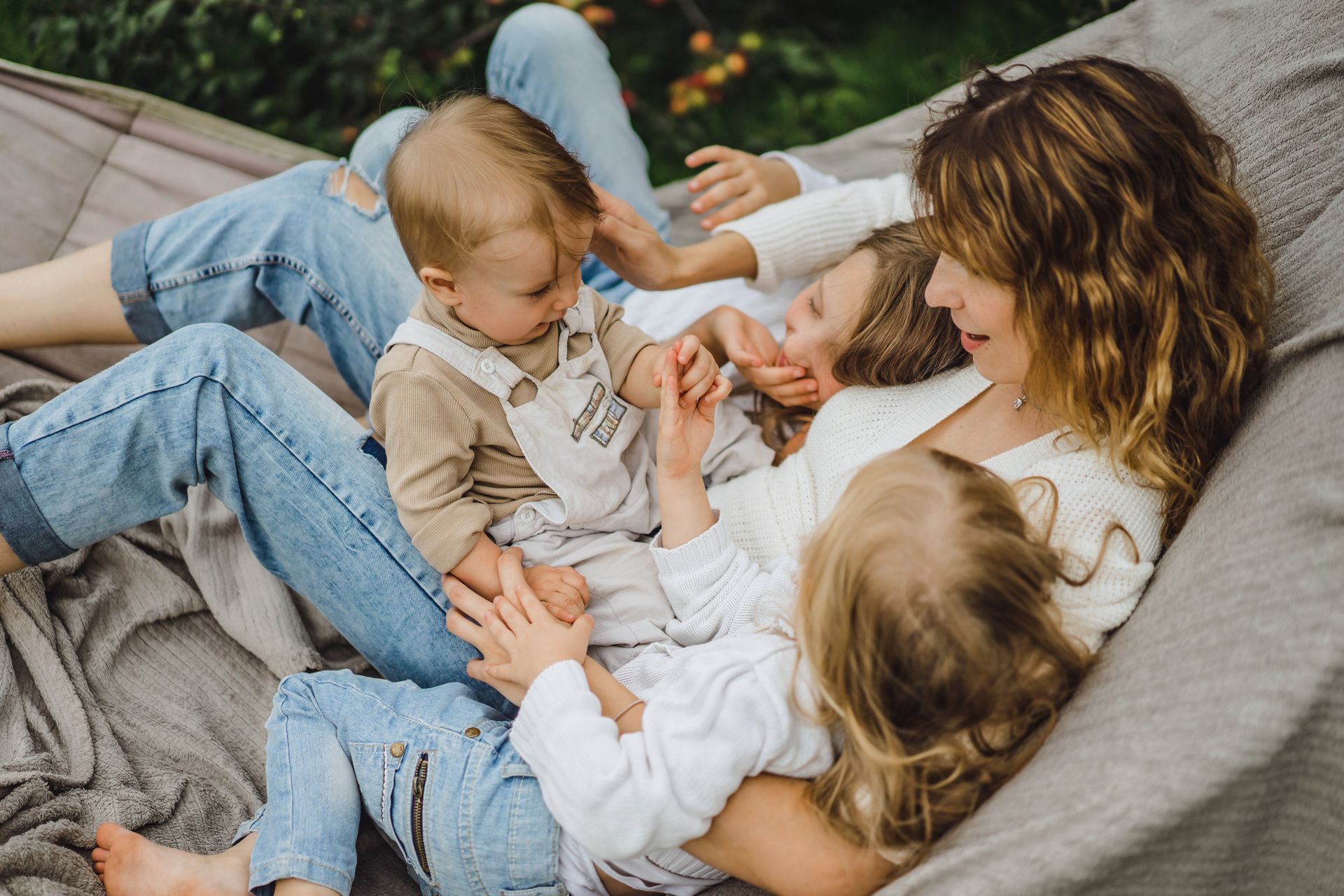 Woman and three children in a hammock, relaxed and interacting.
