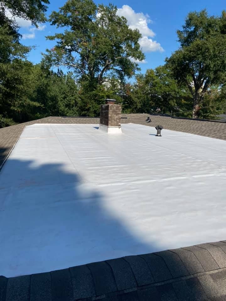 A white roof with a chimney on top of it.