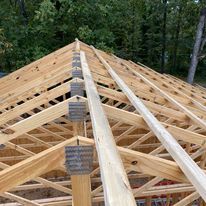 The roof of a building is being built with wooden beams.