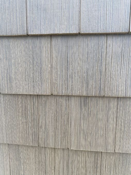 A close up of a wooden siding on a house.