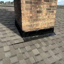A chimney is sitting on top of a brick roof.