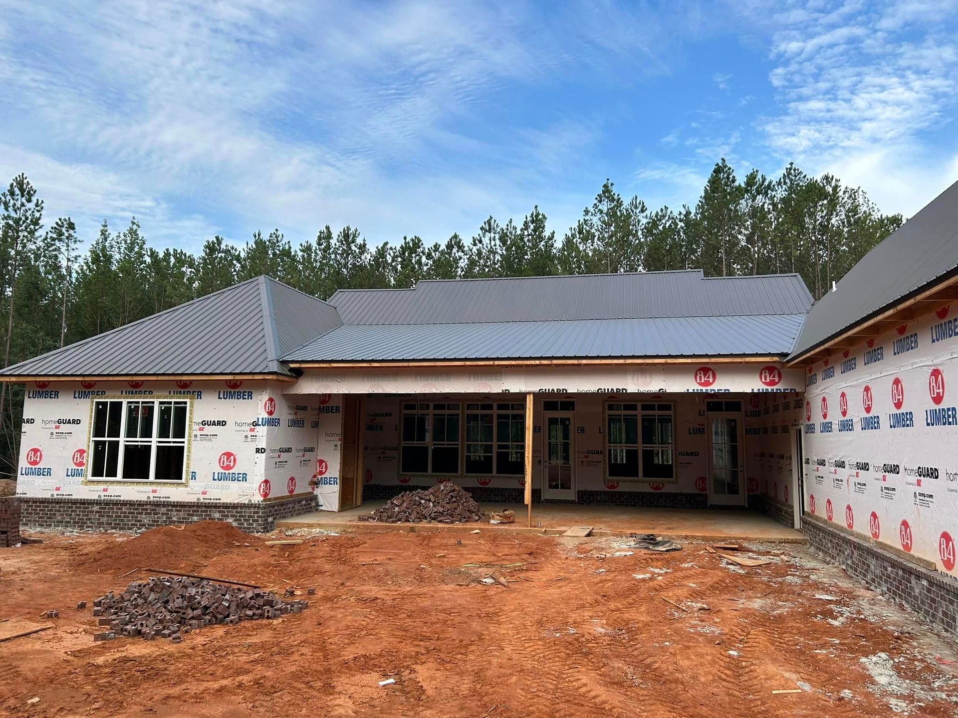 A house that is being built with a lot of windows