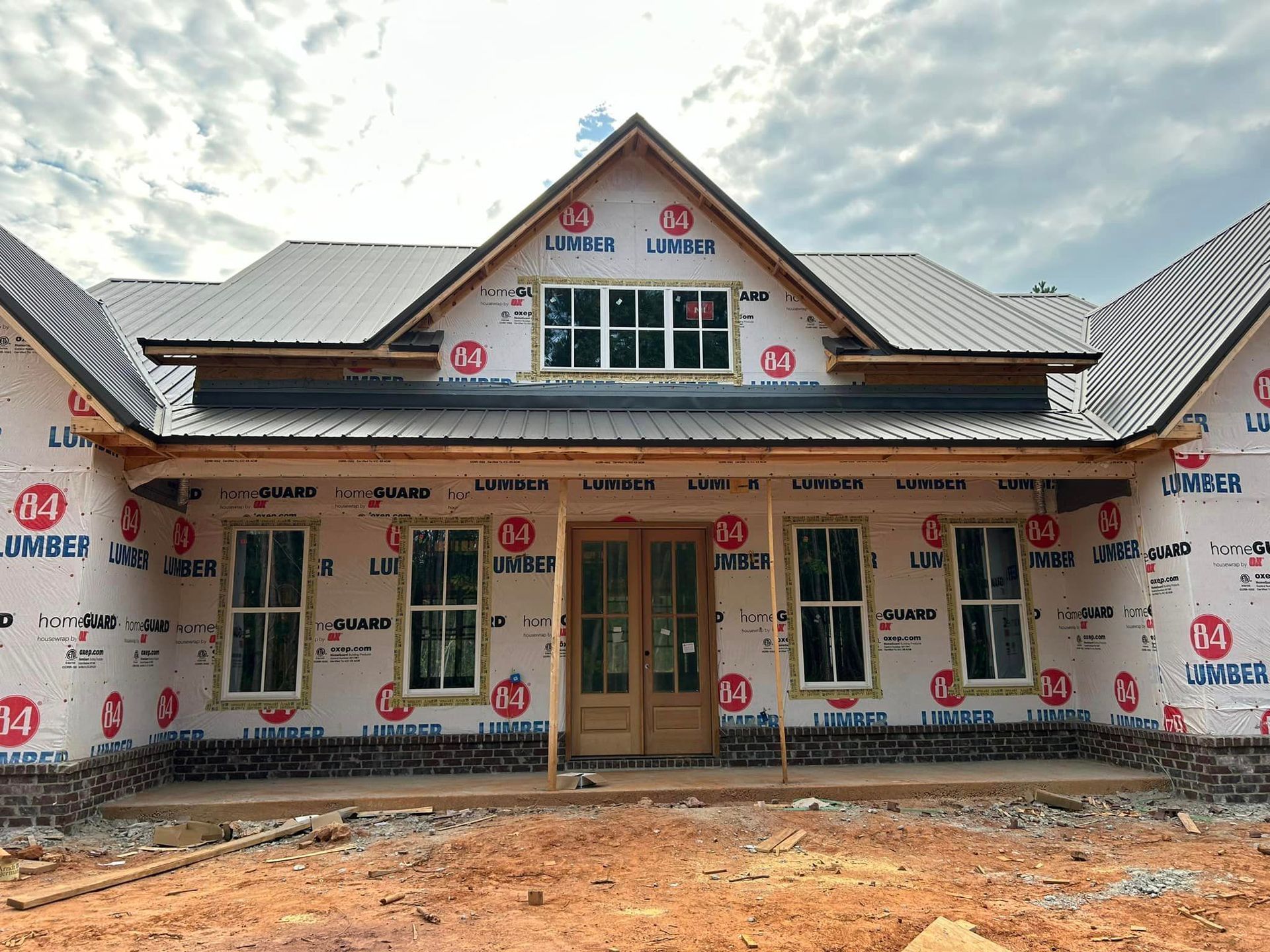 A house that is being built with a lot of windows
