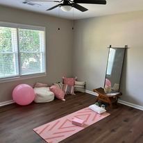 There is a yoga mat in the middle of the room.