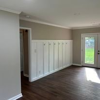 A living room with hardwood floors and a door.