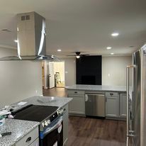 A kitchen with stainless steel appliances and granite counter tops.