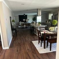 There is a table and chairs in the middle of the room.