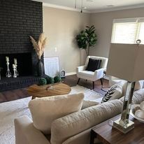 A living room filled with furniture and a fireplace.