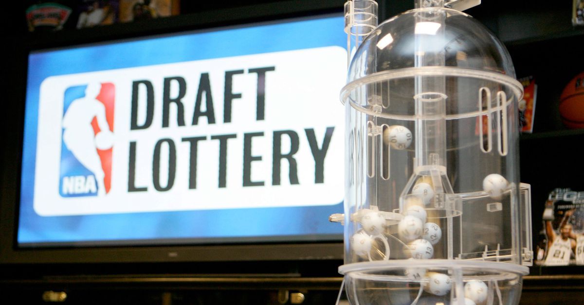 A basketball lottery machine is sitting in front of a sign that says draft lottery.