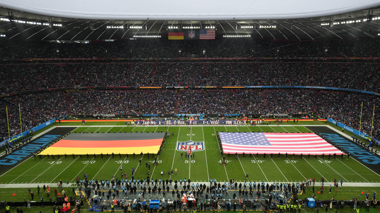 A football stadium with a german and american flag on the field