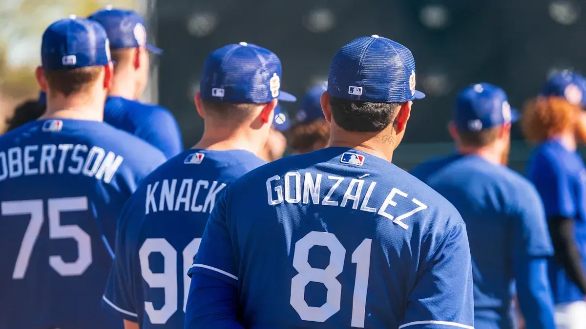 A group of baseball players are standing in a row.