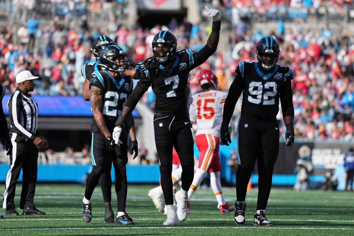 A group of football players are standing on a field.