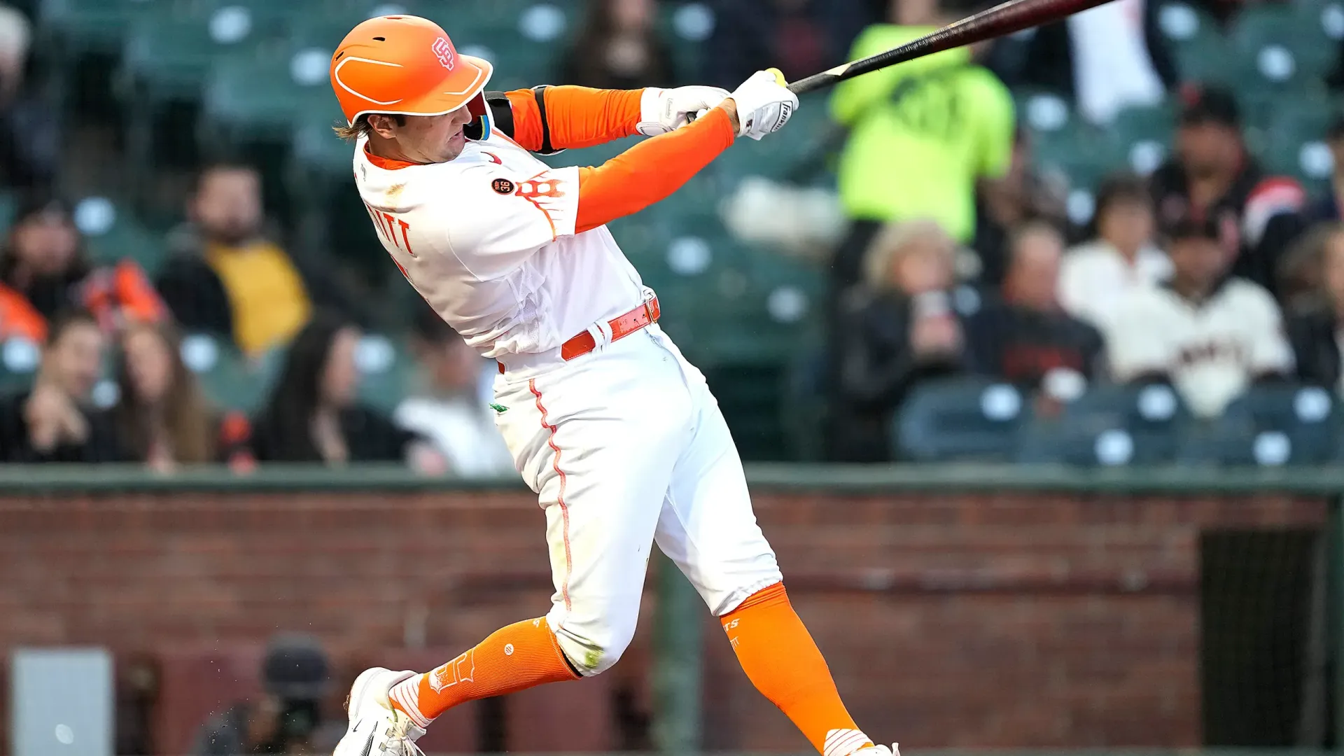 A baseball player is swinging a bat at a ball during a game.