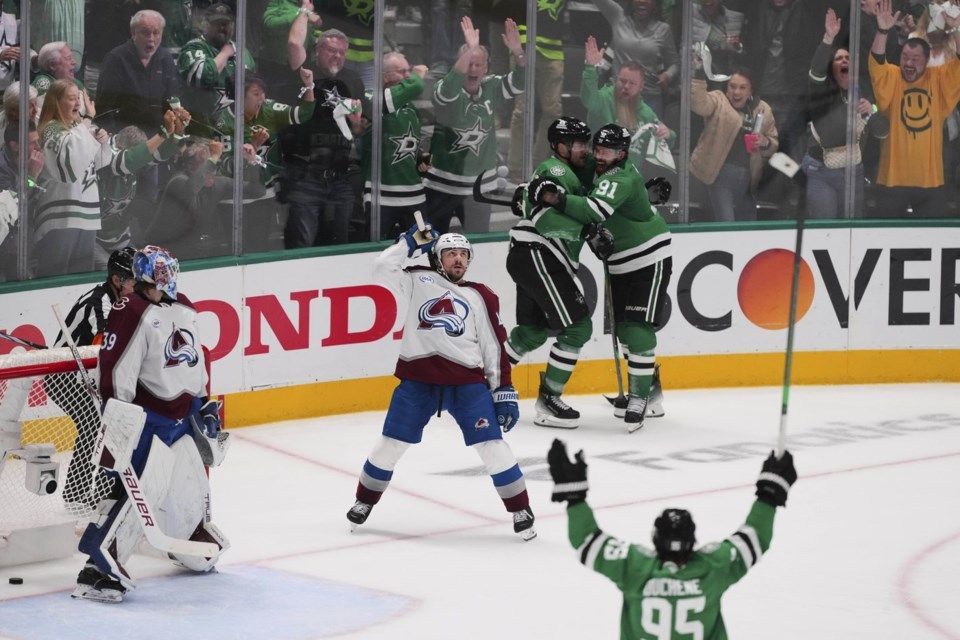 A hockey player with the number 95 on his jersey celebrates a goal