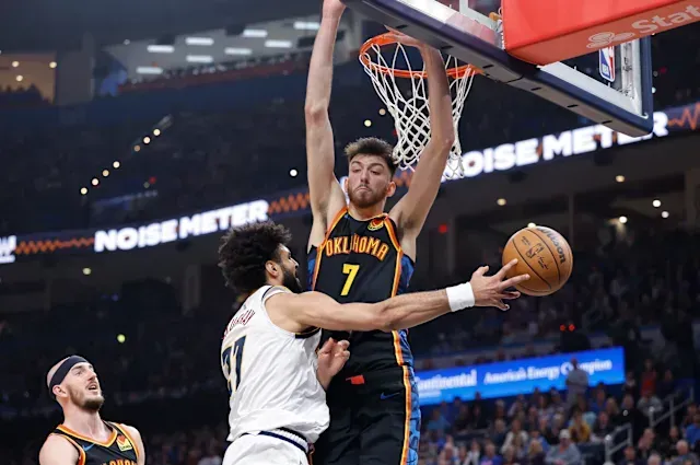 Two basketball players are playing a game of basketball.
