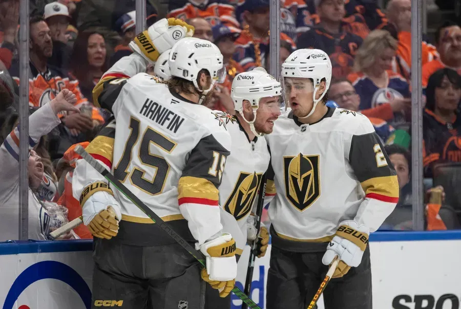A group of hockey players are standing next to each other on the ice.