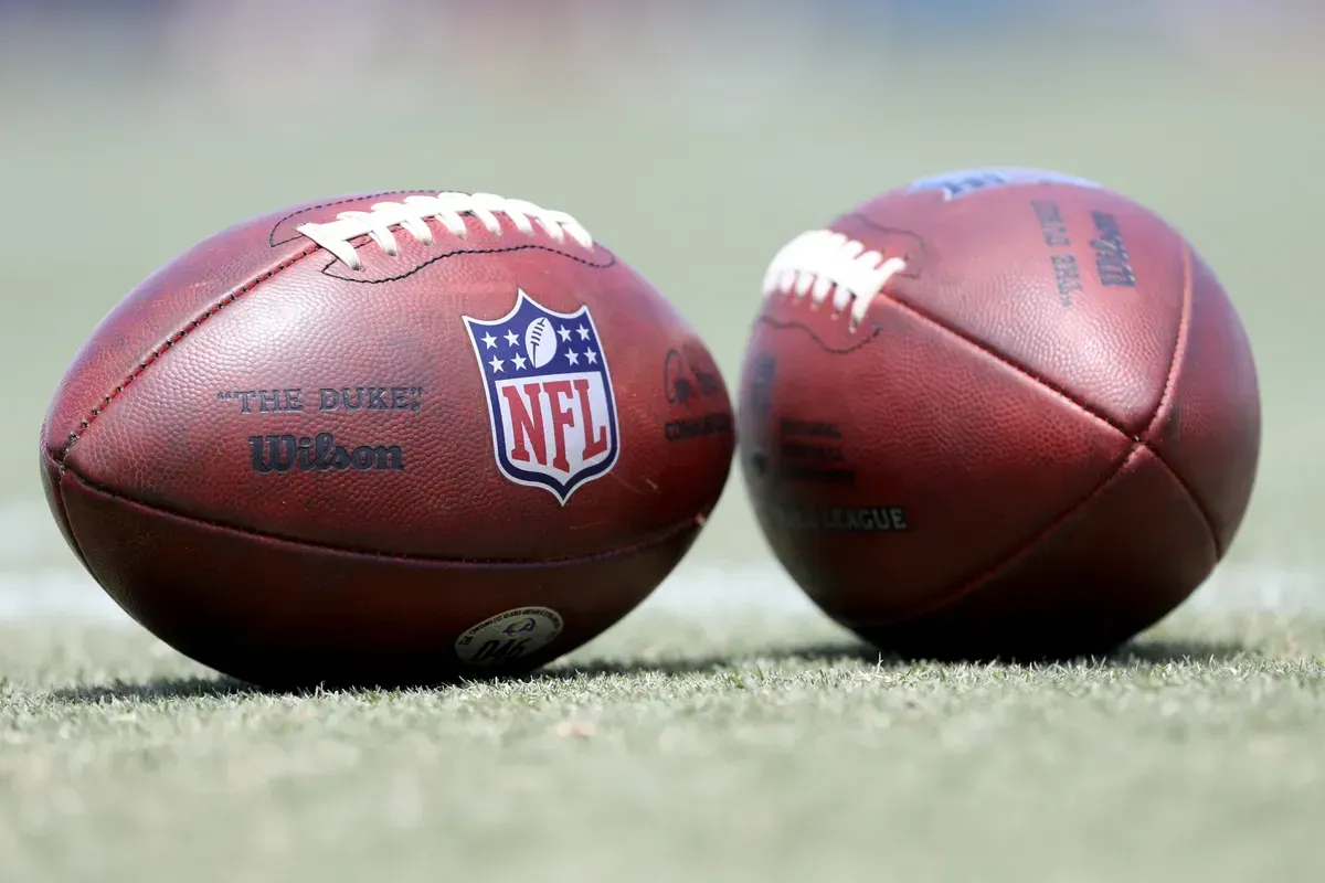 Two footballs with the nfl logo on them