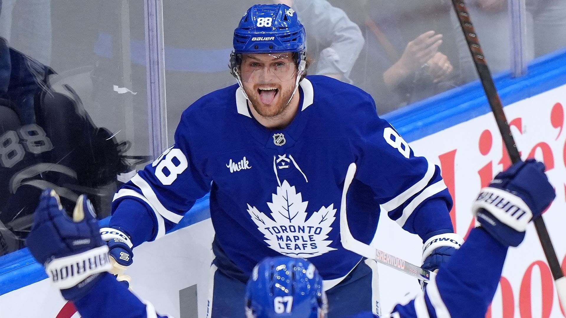 A hockey player is celebrating a goal on the ice.