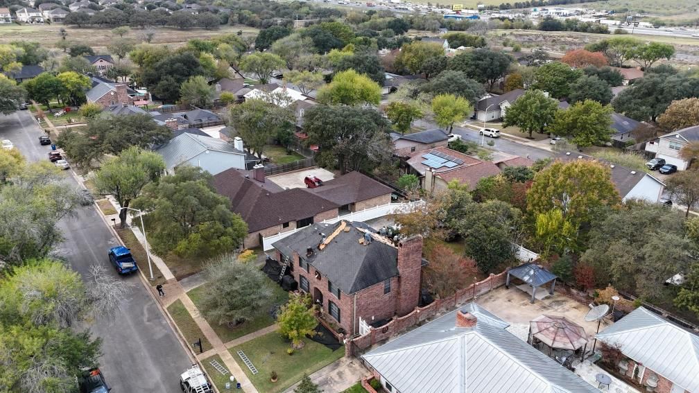 An aerial view of a house with a brown tiled roof.