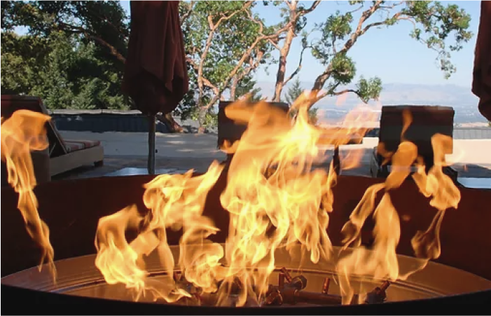 A fire pit with a lot of flames coming out of it