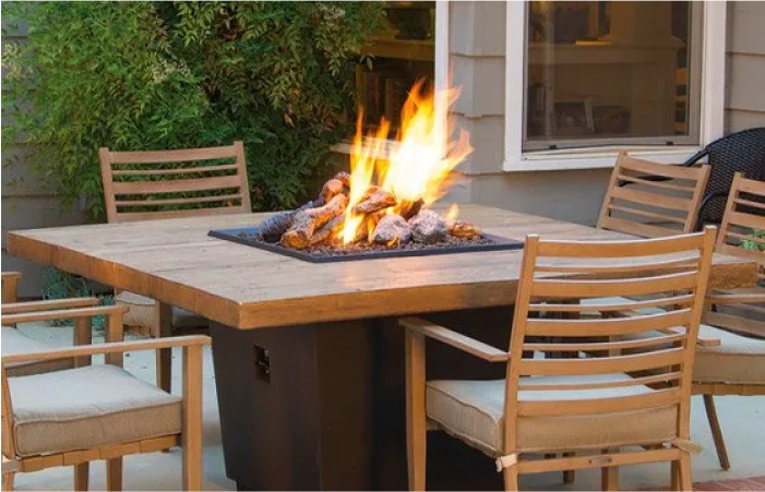 A table with a fire pit in the middle of it