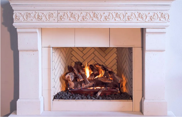 A fireplace with a mantle and a lot of logs in it.