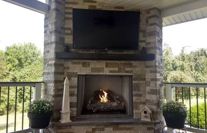 A fireplace with a flat screen tv mounted above it.