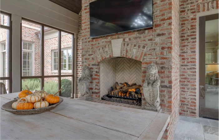 There is a fireplace with a flat screen tv above it.