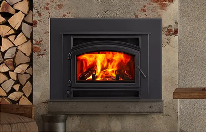 A wood stove is sitting on a wall next to a pile of logs.