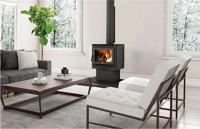 A living room with a wood stove and a couch.